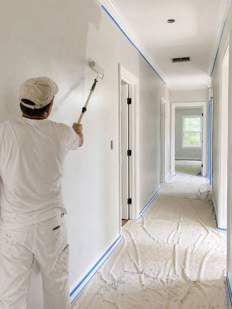 Painter applying a fresh coat to a hallway wall in New Jersey